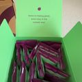 Green box containing purple supplement packets with text "Here's to feeling great, every day, in the easiest way!"
