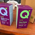 Two purple PurQ supplement boxes on a wooden table - one labeled "Night Time Restore" and one labeled "Gut Care"