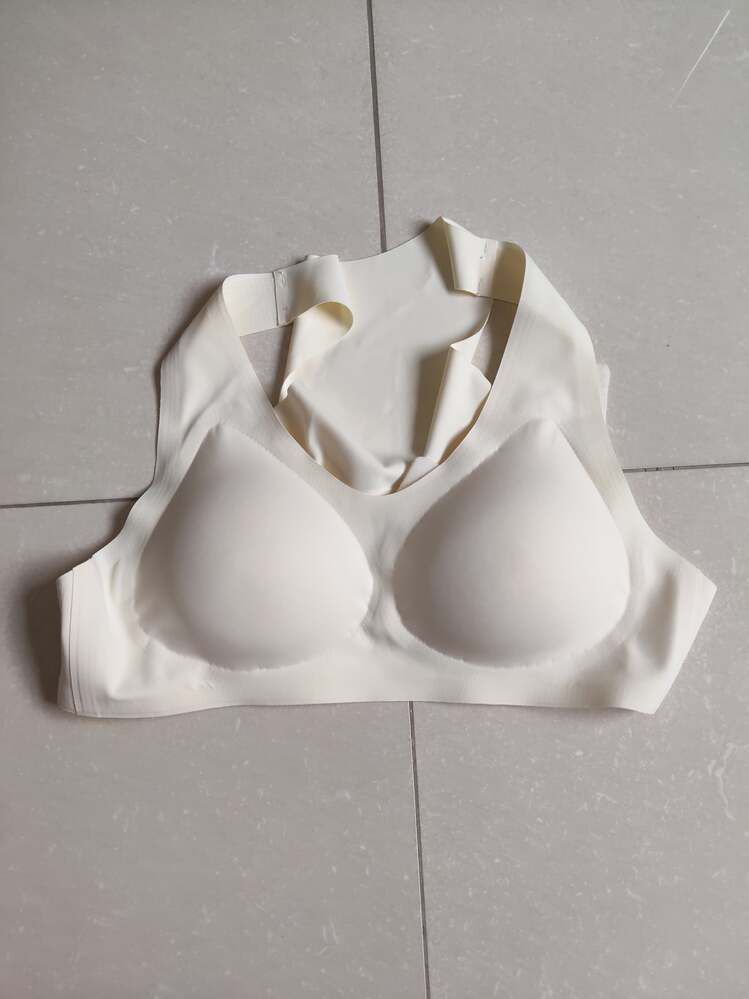 White undergarment laid flat on tiled floor