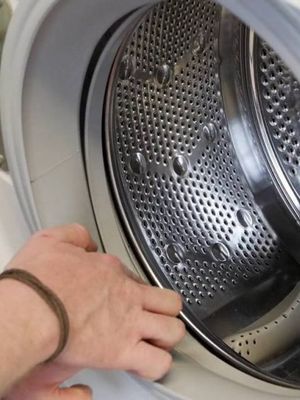 Hand reaching into clean washer
