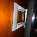 White TV wall mount bracket attached to wooden wall panel