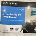 Mount-It low-profile TV wall mount package for 13-50 inch TVs with 0.94 inch profile, showing the product box with mounting bracket visible on the right side.