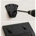 Installation of a black wall-mounted bracket with a power drill being used to secure it to the wall, and a lower image showing the bracket's mounting plate with attachment points.