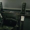 Black metal TV wall mount bracket attached to the back of a flat screen television