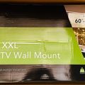 Product packaging for Mount-It Heavy Duty XXL Full-Motion TV Wall Mount for 60-120 inch televisions, showing a modern living room with mounted TV