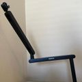 Black adjustable exercise bench positioned against a beige wall on a light wooden surface