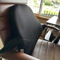Office chair with black mesh back and brown leather seat positioned near a window with blinds