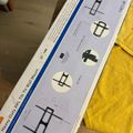 TV wall mount packaging with installation diagrams and instructions laid on a yellow towel