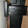 Black adjustment knob or clamp mechanism on what appears to be equipment or furniture hardware
