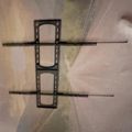 A hand-drawn sketch of what appears to be a SIM card tray with two horizontal lines extending from either side, drawn on white paper