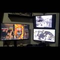 A multi-monitor computer setup displaying various video game content on multiple screens in a dark room