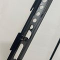 Metal rail or track with circular holes and adjustment mechanism