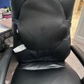 Black office chair with mesh back support and leather seat in a home office setting