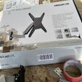 TV wall mount product box on granite countertop with mounting hardware and tape visible