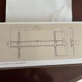 Technical diagram showing mounting bracket assembly with measurements and dimensions on white paper