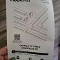 Installation manual for Mount-It on-wall TV cable concealer kit with diagram showing cable management components and contact information