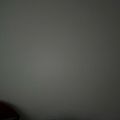 A blurry, dark image with gray tones and indistinct shapes