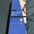 Package for Mount-It MI-9021 Bike Wall Mount with 66 lb weight capacity, showing product box on tiled floor