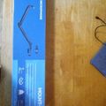 Blue product box for a desk lamp or adjustable light fixture sitting on a wooden surface