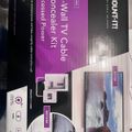 Package for a Mount-It in-wall TV cable concealer kit with recessed power outlets, showing before and after installation images on a purple and black box design