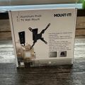 Package box for a MOUNT-IT aluminum pivot TV wall mount showing product features and specifications on wooden surface