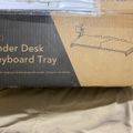 Package box for an under desk keyboard tray with ergonomic positioning and clamp-on installation, showing product illustration on cardboard packaging