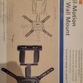 Product packaging for a full-motion TV wall mount showing technical diagrams and a photo of the black mounting bracket with adjustable arms