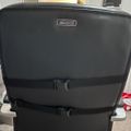 Black Beautyrest luggage suitcase with two buckle straps sitting on a white surface