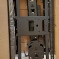 TV wall mount bracket components in cardboard packaging box