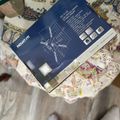 IKEA instruction manual for furniture assembly lying on a patterned fabric surface