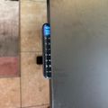 Elevator control panel with digital display showing floor number and directional arrow buttons mounted on metallic elevator door
