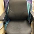 Gray office chair with purple and teal blanket draped over the back
