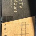 A tilting TV wall mount product box showing installation diagrams and specifications