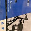 Product packaging for a black bike wall mount with shelf and hooks, showing the mounting hardware against a blue background