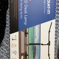 LED desk lamp product box showing adjustable lamp design and swing arm features on packaging