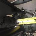A measuring tape showing measurements near bicycle components and mechanical parts