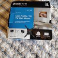 Package for a MOUNT-IT low-profile tilt TV wall mount for 13-50 inch TVs, showing product details and specifications on the box
