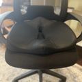 Black office chair with mesh backrest and fabric seat cushion on wheels