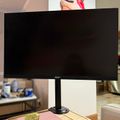 Acer computer monitor with black screen on desk stand in home office setting