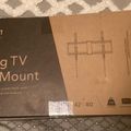 A boxed TV wall mount product showing packaging with Mount-It brand name and tilting wall mount specifications for 42-80 inch TVs