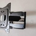 TV wall mount bracket with articulating arm extended, showing metal mounting plate and adjustment mechanisms