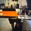 Person holding a large TV wall mount box in a home setting