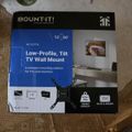 Package for a Mount-It low-profile tilt TV wall mount for 13-50 inch TVs, showing product features and specifications on the box