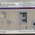 Package for an in-wall TV cable concealer kit with recessed power outlets, showing product diagram and white wall plate components