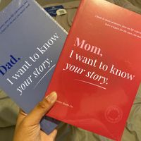 Two memory books held in hands