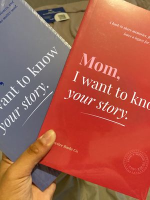 Two memory books held in hands