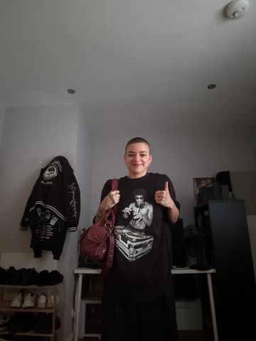 Customer L W. giving two thumbs up in a DJ Bruce Lee tee