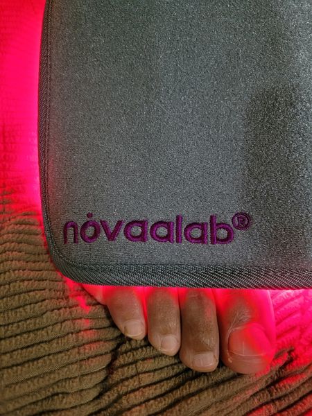 Novaa Light Pad red light therapy device in use on a foot