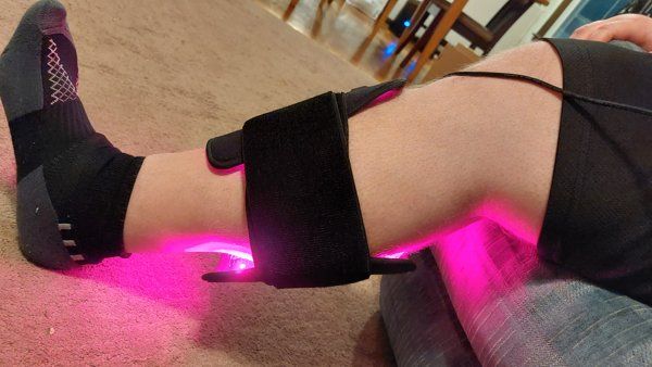Novaa Light Pad strapped around a forearm with the LEDs lit