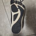 A black and white shoe sole lying on a tiled floor